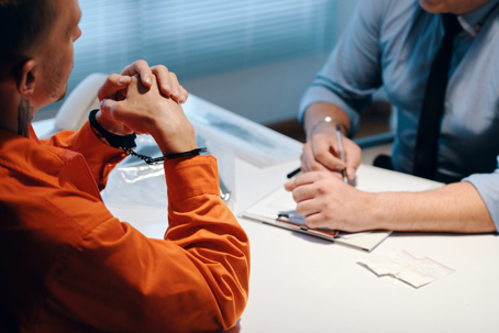 Lawyer talking to their client in jail